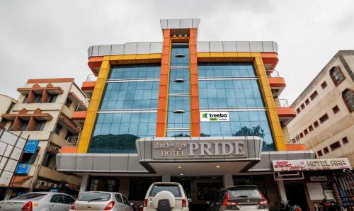 a building with cars parked in front of it at Treebo Trend Pride in Mysore