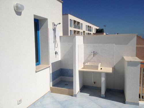 a bathroom with a sink on the side of a building at Appartamento Selinunte in Marinella di Selinunte