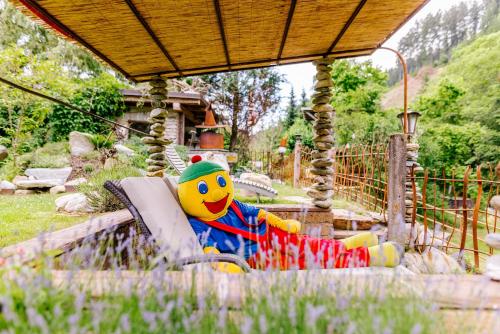 a stuffed toy sitting on a ride in a park at Smileys Fluss Chalet in Trebesing