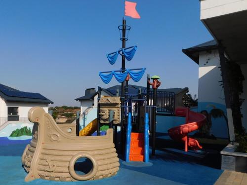 a childrens playground with a slide and a slideintend at Ballito Beach Vibes at Ballito Hills in Ballito