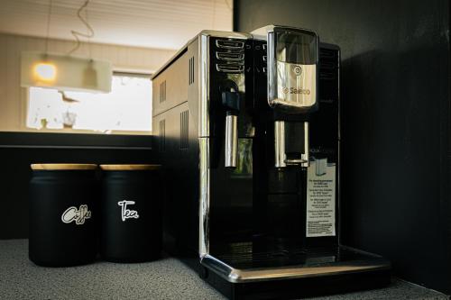 a coffee machine in a room with two trash cans at Beautiful family home in South-Iceland perfect for groups and families in Hella