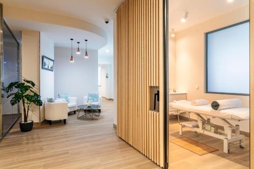 a hospital room with a bed and a table at Suites del Mar by Melia in Alicante