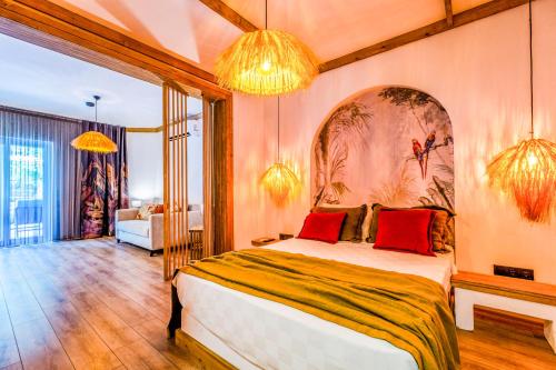 a bedroom with a large bed with red pillows at Costa Bodrum City in Bodrum City