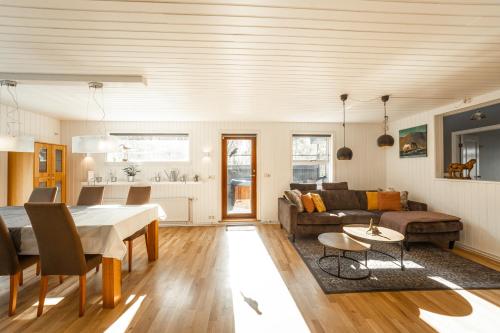 a living room with a table and a couch at Beautiful family home in South-Iceland perfect for groups and families in Hella