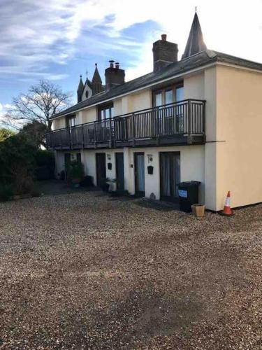 a large house with a balcony on top of it at 2 Dorset Mews in Lyme Regis
