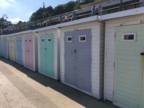 a row of portable bathrooms with people sitting on top at 2 Dorset Mews in Lyme Regis