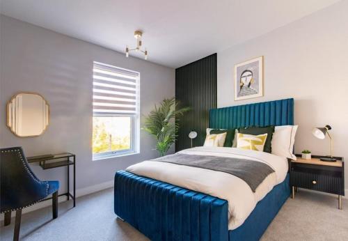 a bedroom with a large blue bed and a chair at Margaret Street in Sheffield