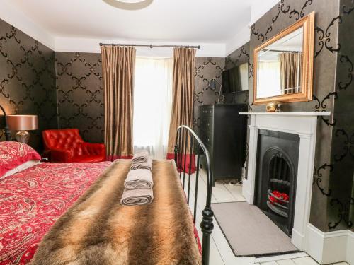 a bedroom with a bed and a fireplace at The Farmhouse in North Walsham