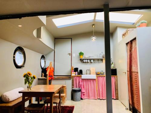 a kitchen with a table and a dining room at Houseboat Tante Piet in Amsterdam