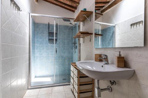 a bathroom with a sink and a shower at Antica Porta di Sovana in Pitigliano