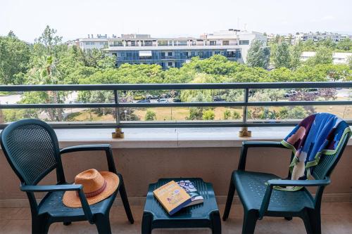 two chairs and a table on a balcony with a view at Hotel California Palace in Salou