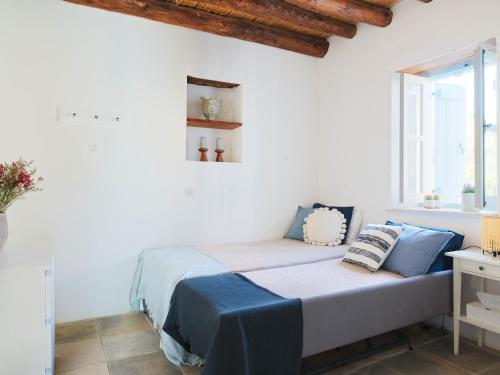 a bedroom with a bed in a white room at Villa Avgoustis in Pachna