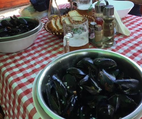 a bowl of mussels sitting on top of a table at Apartment Simo in Herceg-Novi