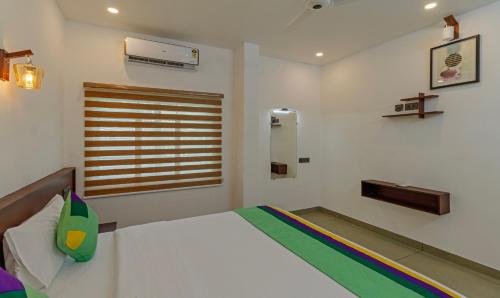a bedroom with a white bed and a window at Treebo Amigos Residency Cochin Airport Hotel in Cochin