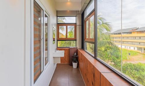 a bathroom with a sink and large windows at Treebo Amigos Residency Cochin Airport Hotel in Cochin