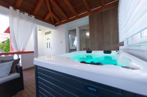 a large bathroom with a large tub with blue water at Luxury Residence with jacuzzi-LONG ISLAND in Sali