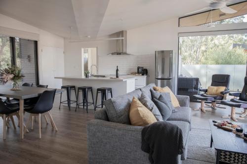 a living room and kitchen with a couch and a table at Villa View in Halls Gap