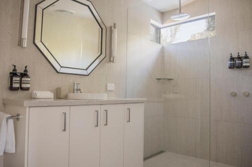 a bathroom with a sink and a shower with a mirror at Villa View in Halls Gap