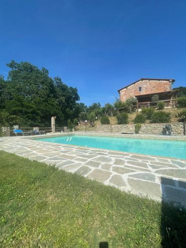 a swimming pool in front of a building at B&B Alloro in Capannori