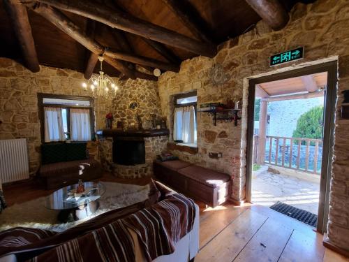 a living room with a couch and a fireplace at Yono's Traditional House in Ano Ravenia