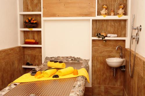 a small bathroom with a bed and a sink at Hotel AlpenSonne Ruhpolding in Ruhpolding