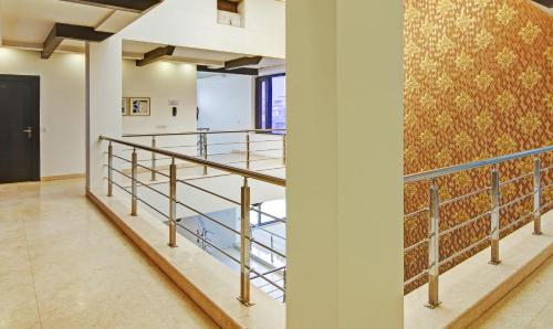 a staircase in a building with a wall with a mural at Blue Moon Residency Hotel & Restaurant in Gurgaon