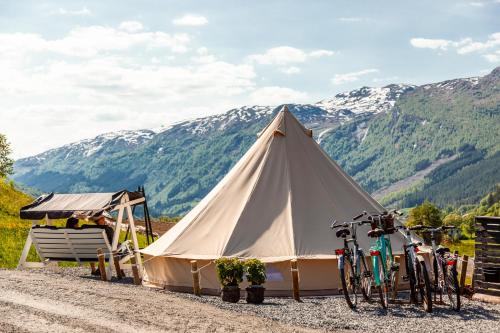 a white tent with bikes parked in front of it at Tuftegarden in Viksdalen