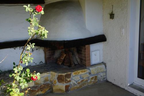 a brick fireplace in the corner of a house at HERZLI-CHALET über dem Rheintal mit Schlossblick in Werdenberg