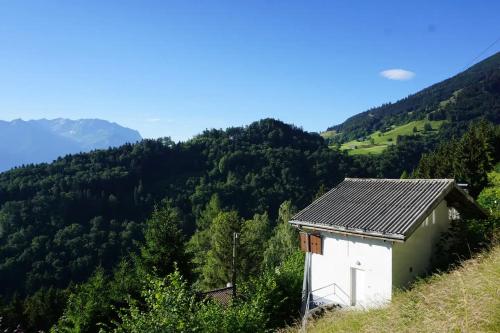 a small house on the side of a mountain at HERZLI-CHALET über dem Rheintal mit Schlossblick in Werdenberg