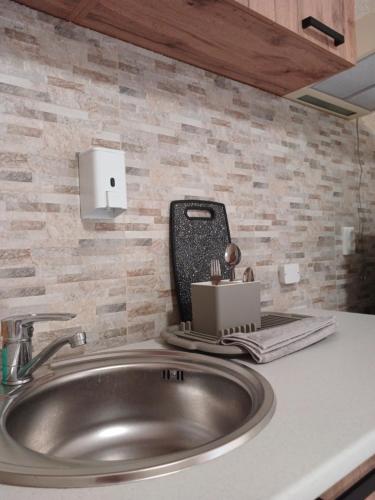 a bathroom sink with a cell phone on top of it at Готель Гармонія. Термально-оздоровчий комплекс. in Uzhhorod