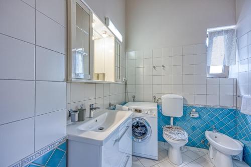 a bathroom with a sink and a washing machine at Apartment Ana with Balcony in Stranići kod Lovreča