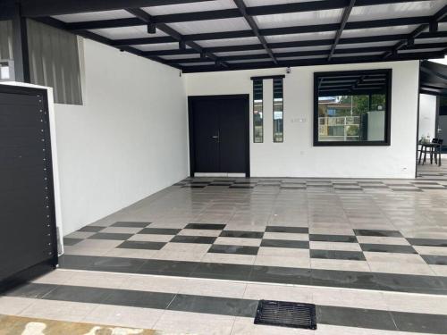 a room with a black door and a checkered floor at Abbie's Private Pool Villa Bukit Mertajam Penang in Bukit Mertajam
