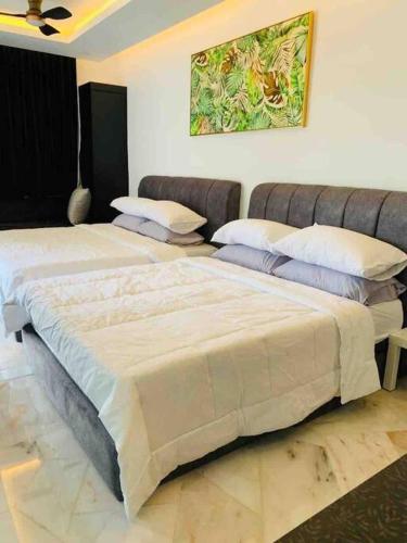 a bedroom with two beds and a couch at Abbie's Private Pool Villa Bukit Mertajam Penang in Bukit Mertajam