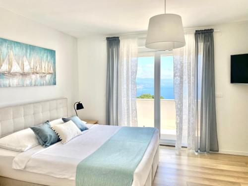 a bedroom with a bed with a view of the ocean at Villa Marta in Opatija