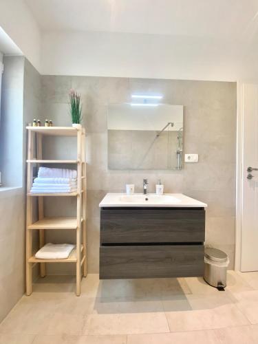 a bathroom with a sink and a mirror at Villa Marta in Opatija