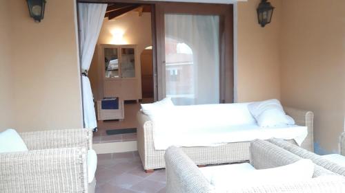a living room with two chairs and a couch at Casa Logos Stintino - Private pool in Stintino