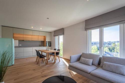a living room with a couch and a table at Renovated 2 Bedroom Apartment with Parking & AC in Luxembourg