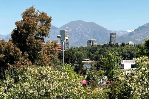 a view of a city with trees and buildings at Grand Central Apartment LTH in Tirana
