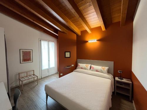 a bedroom with a white bed and a window at Agriturismo Corte Ambrosio in Pozzolengo