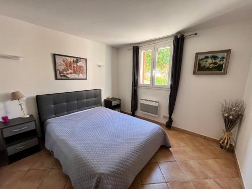 a bedroom with a bed and a window at residence Catalani in Zonza