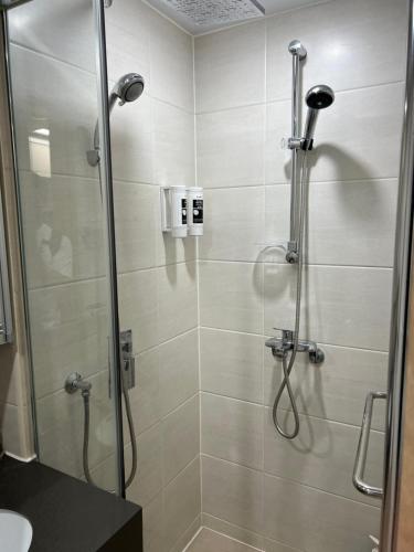 a shower with a glass door in a bathroom at Sokcho Marinabay 305 "Lake View" in Sokcho
