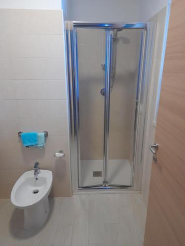 a bathroom with a shower and a toilet and a sink at Hotel La Giara in Montauro