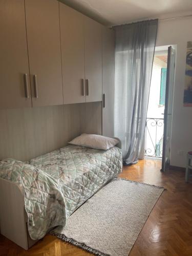 a bedroom with a bed and a cabinet and a rug at L'Isola dei Sapori in Monte Isola