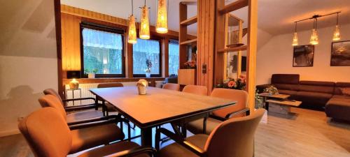 a dining room and living room with a table and chairs at IQBAL-Hütte (die Moorperle) in Beverstedt