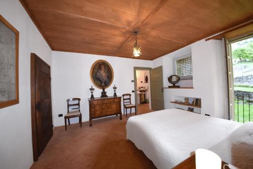a bedroom with a bed and a table and chairs at Piano nobile al Roseto del Drago in San Bernardo