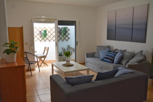 a living room with two couches and a table at Apartamento Salitre in Puertito de Güímar