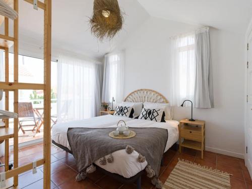 a bedroom with a bed with a table on it at Casa Velero to 100mt from beach , optical fiber in La Oliva