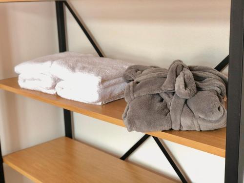 a pile of towels sitting on a shelf at Mountain Houses Kubínska hoľa in Dolný Kubín