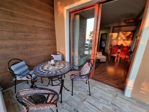 a patio with a table and chairs on a balcony at Dreamland Oasis in Chakvi in Chakvi