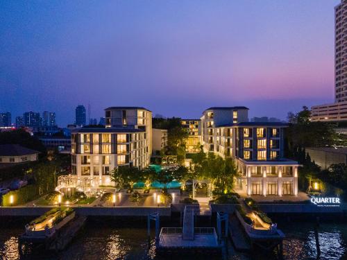 a view of a city at night at The Quarter Chaophraya by UHG in Bangkok